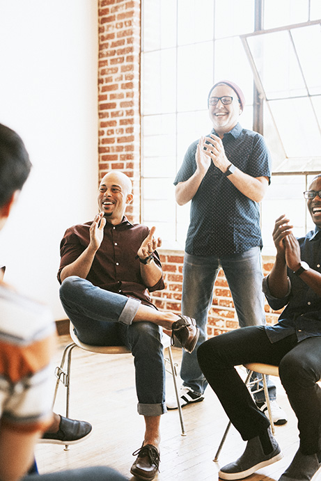 People clapping their hands in a meeting