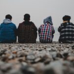 Young men sitting on a beach