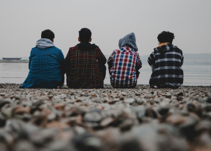 Young men sitting on a beach