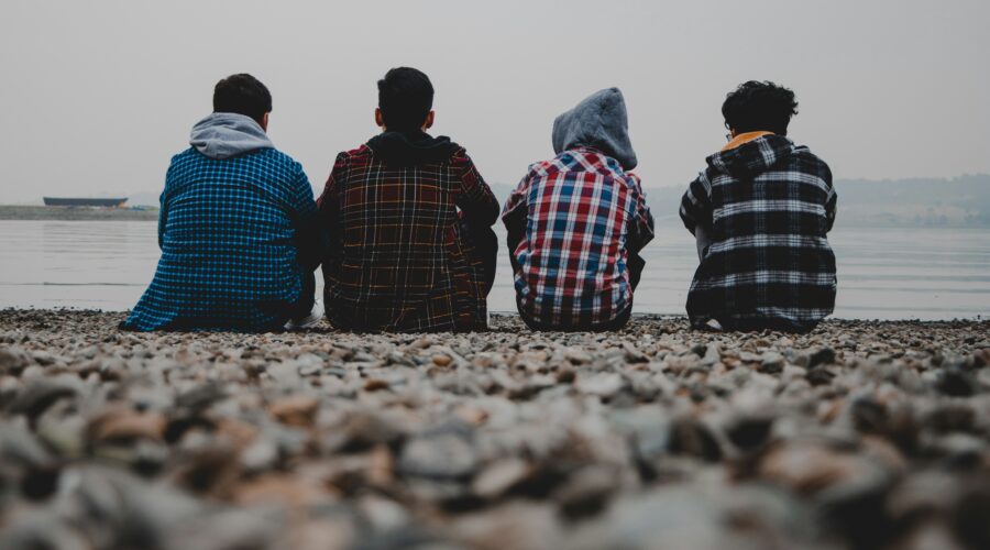 Young men sitting on a beach