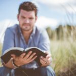 Christian leadership begins with following Jesus, man reading his Bible