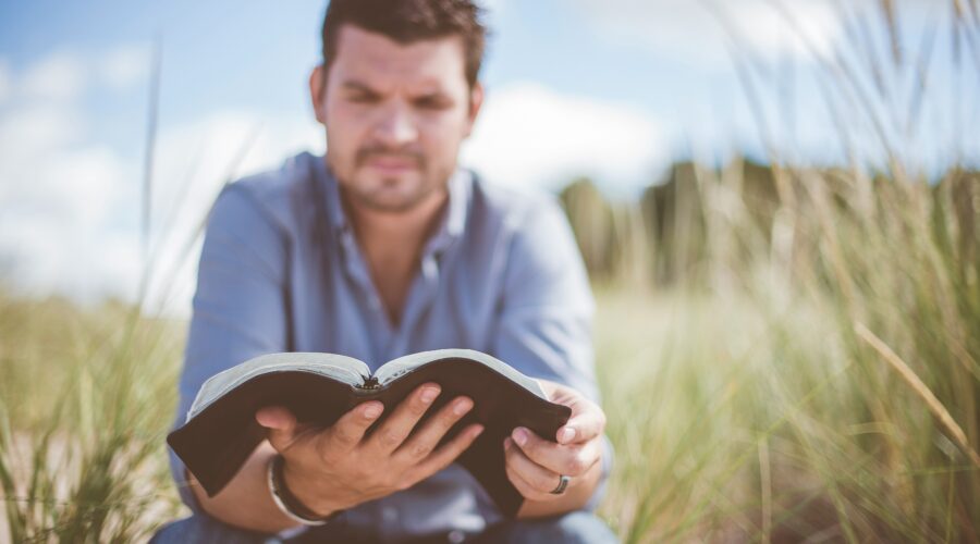 Christian leadership begins with following Jesus, man reading his Bible