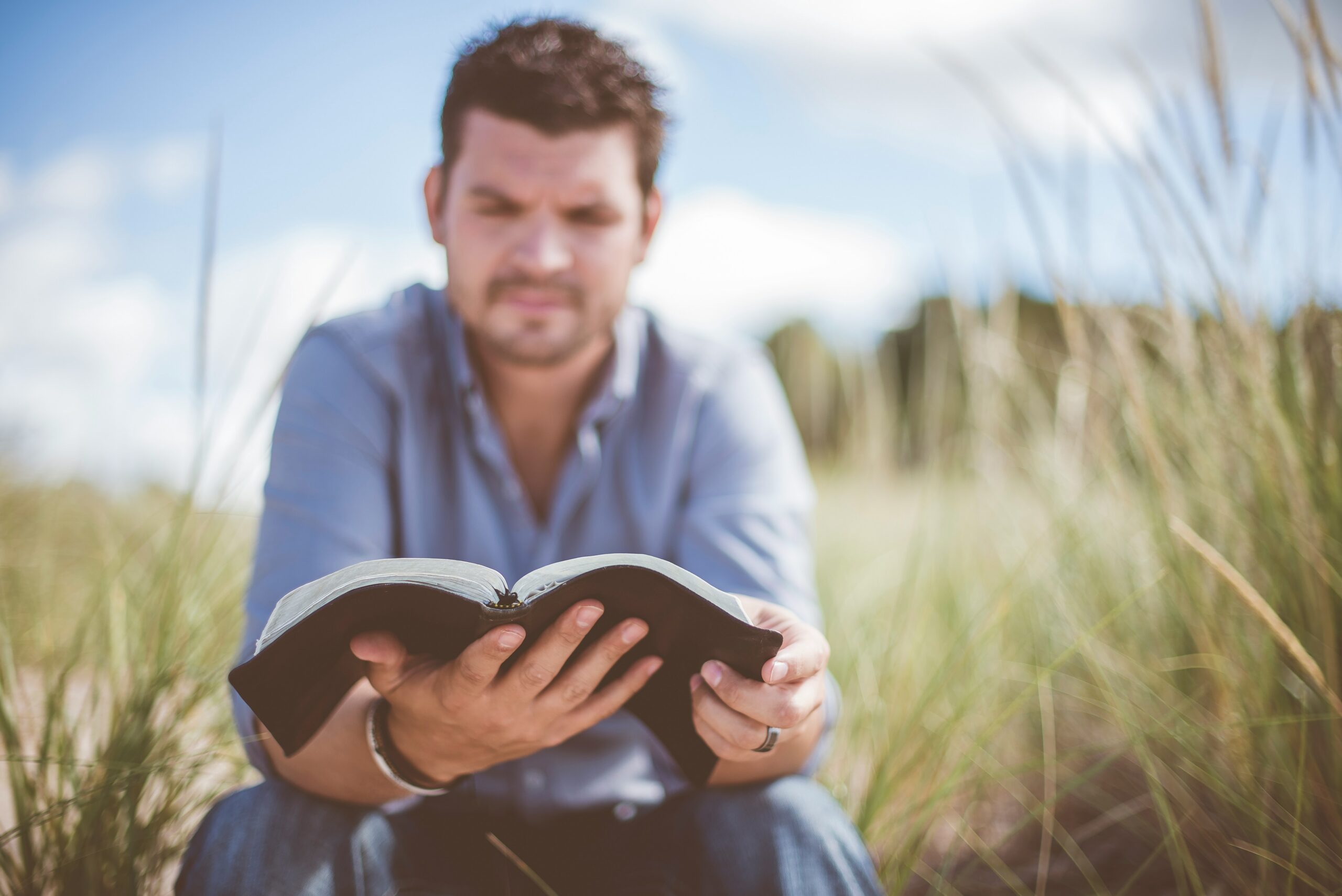 Christian leadership begins with following Jesus, man reading his Bible
